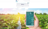 a cultivated field and a hand keeping a smartphone